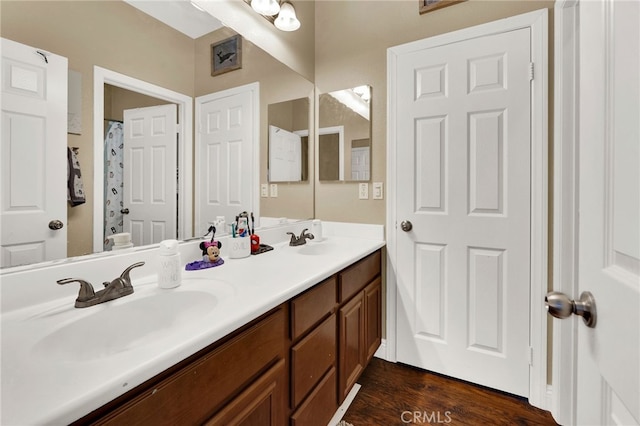 bathroom with vanity, wood-type flooring, and shower / bath combo