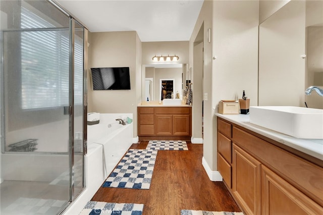 bathroom featuring vanity, wood-type flooring, and independent shower and bath