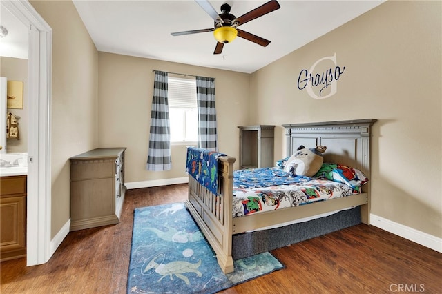 bedroom with dark hardwood / wood-style flooring, sink, and ceiling fan