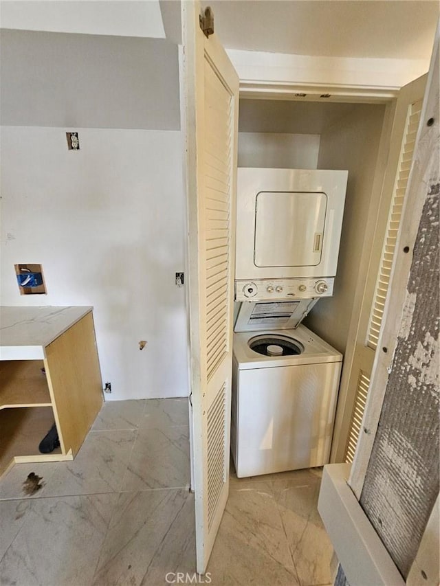 laundry area featuring stacked washer and dryer