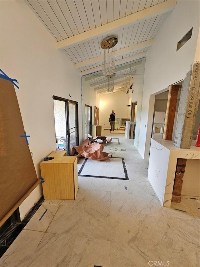 corridor featuring high vaulted ceiling and beam ceiling