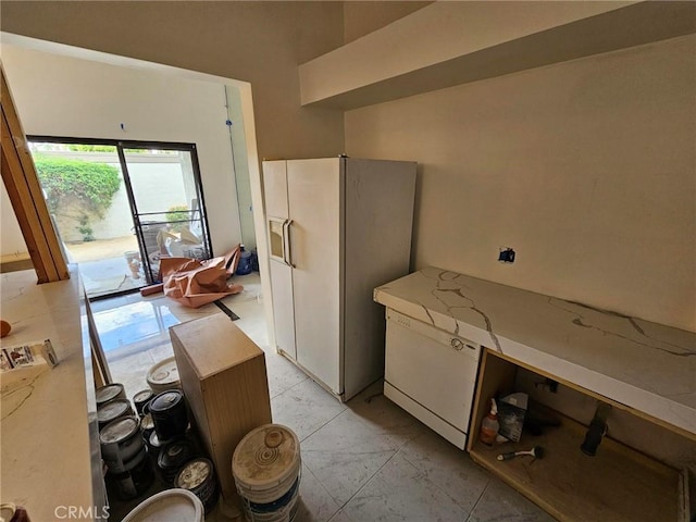 kitchen with white fridge with ice dispenser and light tile patterned floors