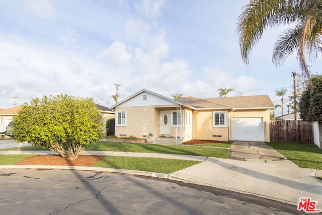 ranch-style home featuring a garage and a front lawn