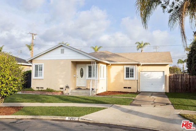 ranch-style house with a garage and a front lawn