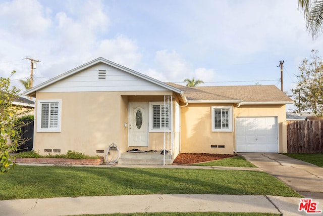 single story home with a garage and a front yard