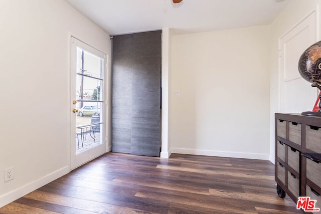 empty room with dark hardwood / wood-style floors