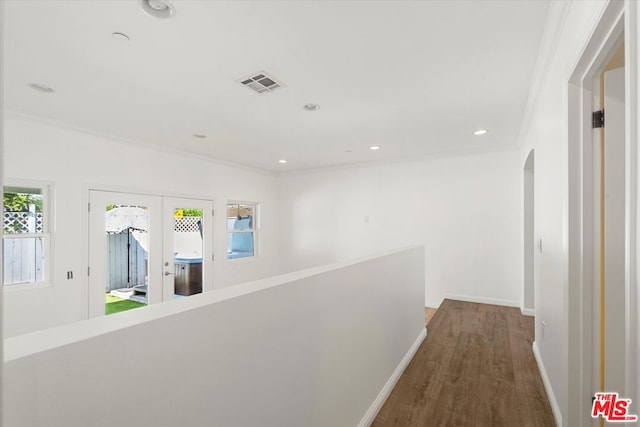 hallway with crown molding, hardwood / wood-style flooring, and french doors