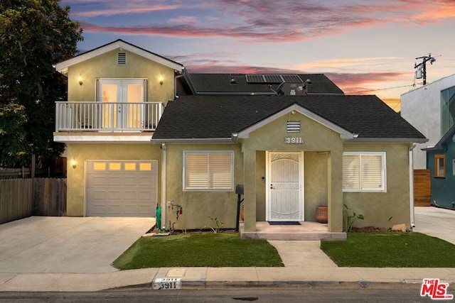 view of front of home featuring a garage and a balcony