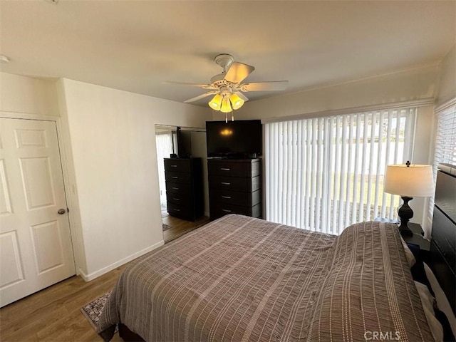 bedroom with ceiling fan and wood-type flooring