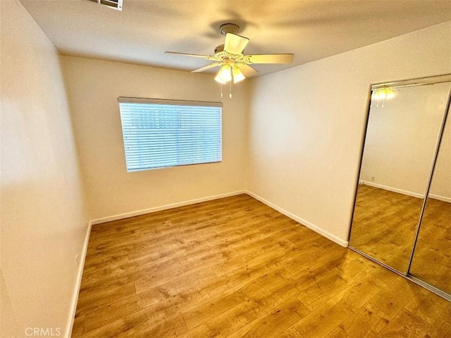 unfurnished bedroom with a closet, ceiling fan, and light hardwood / wood-style floors