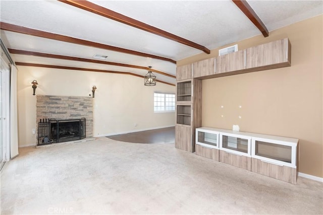 unfurnished living room featuring baseboards, visible vents, lofted ceiling with beams, carpet flooring, and a fireplace