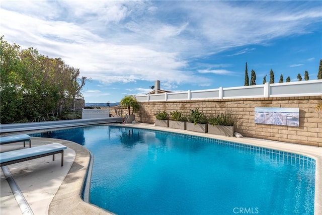 view of pool with a patio area, fence, and a fenced in pool