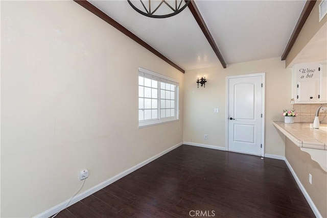 25609 Oakbar Ct, Newhall, CA 91321 - unfurnished dining area with dark wood finished floors, beamed ceiling, and baseboards