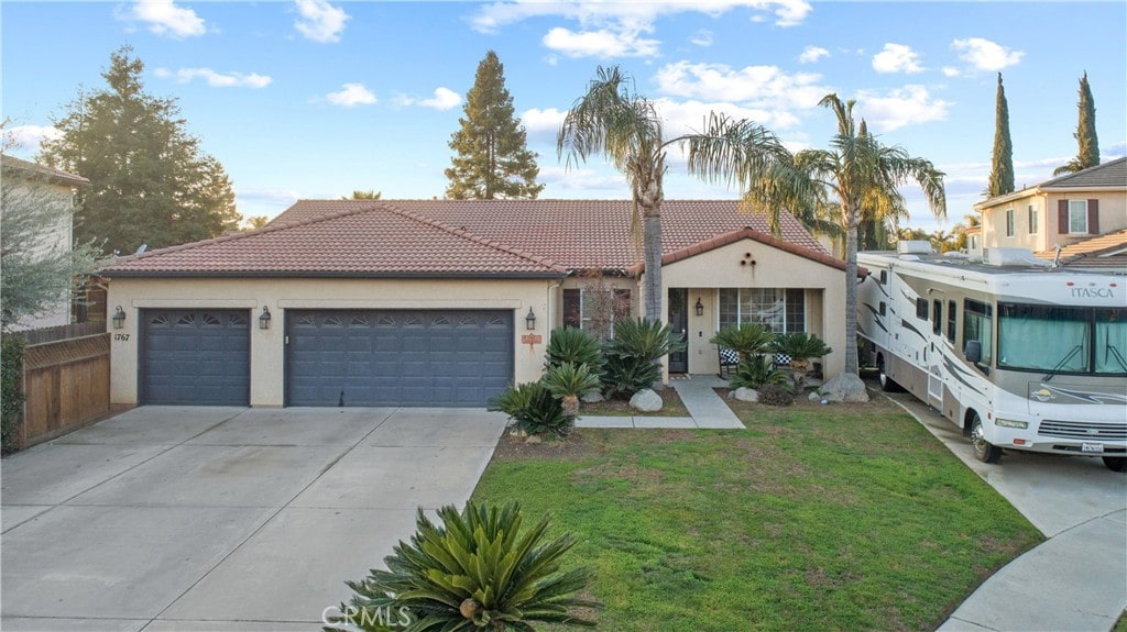 view of front of house with a garage and a front lawn