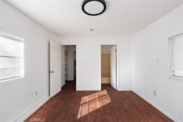 unfurnished bedroom featuring dark hardwood / wood-style flooring and a closet