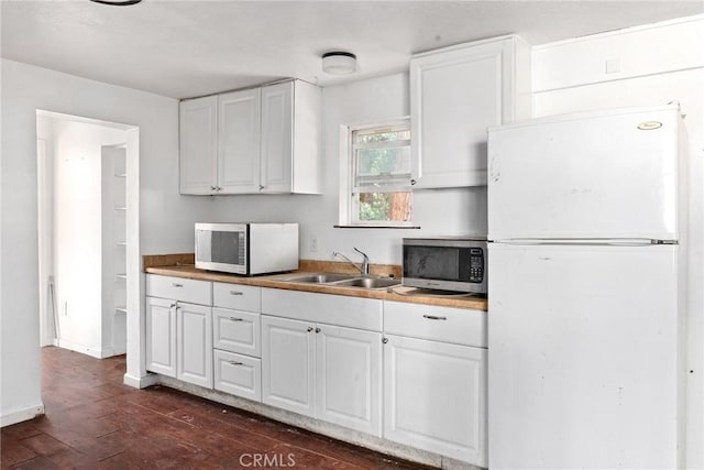 kitchen with white cabinetry, sink, dark wood-type flooring, and white refrigerator