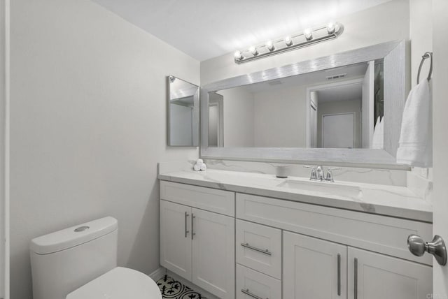 bathroom featuring visible vents, vanity, and toilet