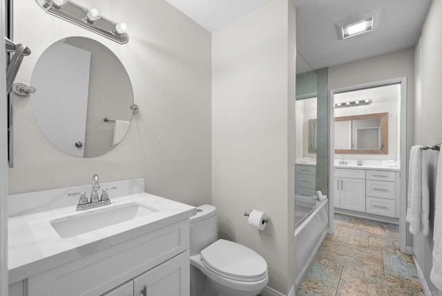 bathroom with stone finish flooring, two vanities, a sink, and visible vents