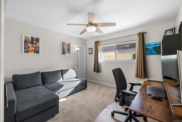 office area featuring light carpet, ceiling fan, and baseboards