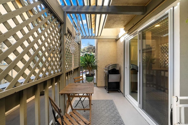 balcony with a pergola and area for grilling