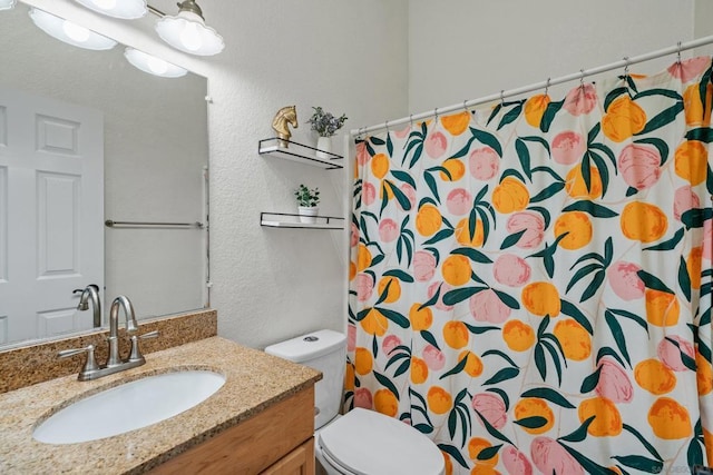 bathroom featuring vanity, toilet, and a shower with shower curtain