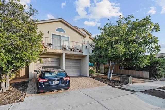 view of front of home featuring a garage and a balcony