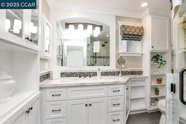 bathroom with vanity, toilet, a shower with shower door, and tile patterned flooring