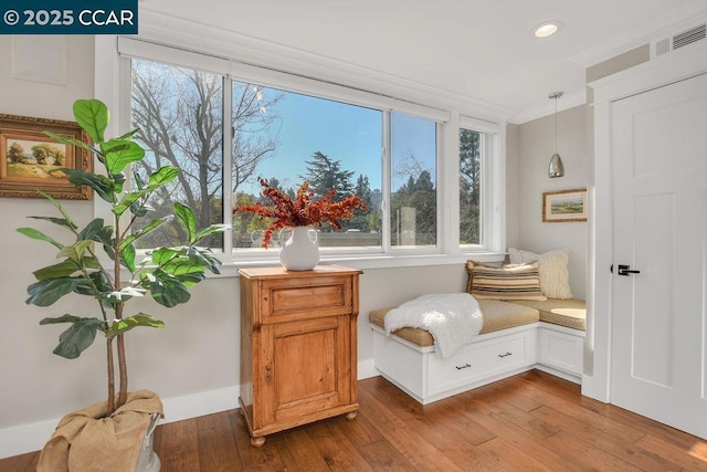 sitting room with hardwood / wood-style flooring and plenty of natural light