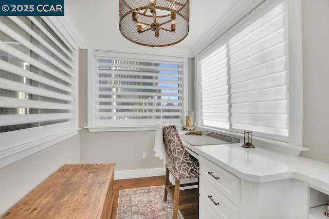 home office with ornamental molding, dark hardwood / wood-style floors, and built in desk