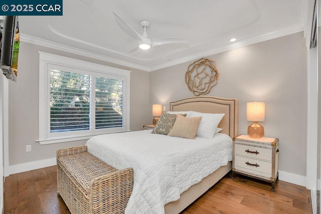 bedroom with crown molding, ceiling fan, and hardwood / wood-style floors