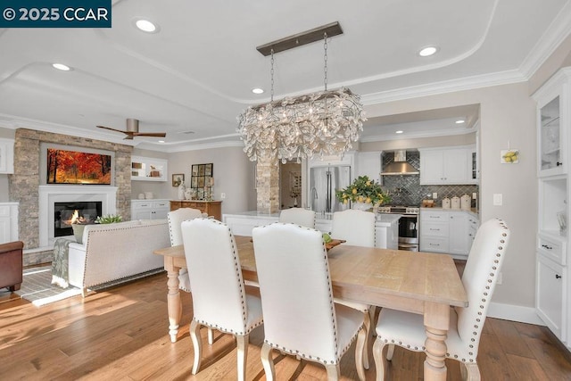 dining room featuring ornamental molding, a notable chandelier, and light wood-type flooring