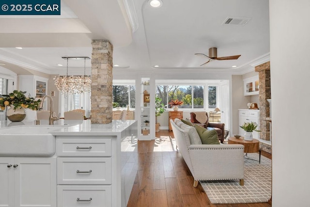 interior space with crown molding, sink, ceiling fan, and dark hardwood / wood-style flooring