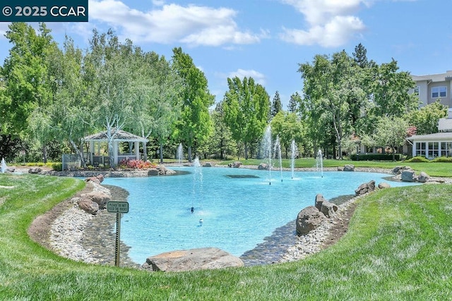 view of pool with a gazebo and a lawn