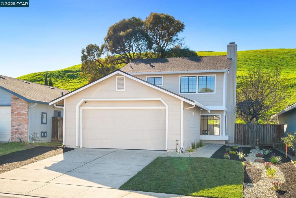 front facade featuring a garage and a front lawn