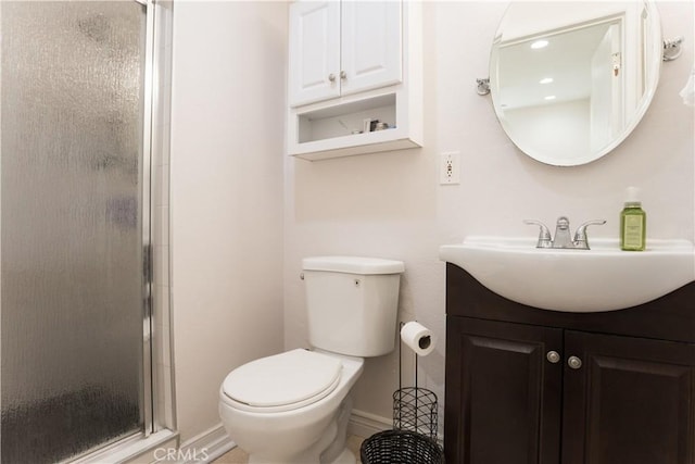 bathroom featuring vanity, toilet, and walk in shower