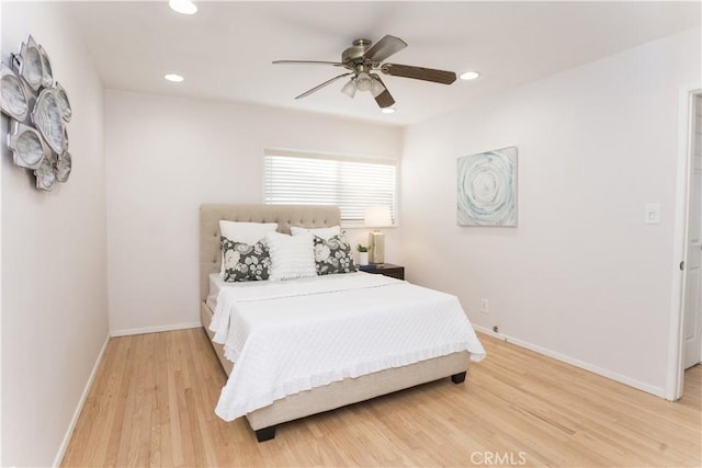 bedroom with ceiling fan and light hardwood / wood-style flooring