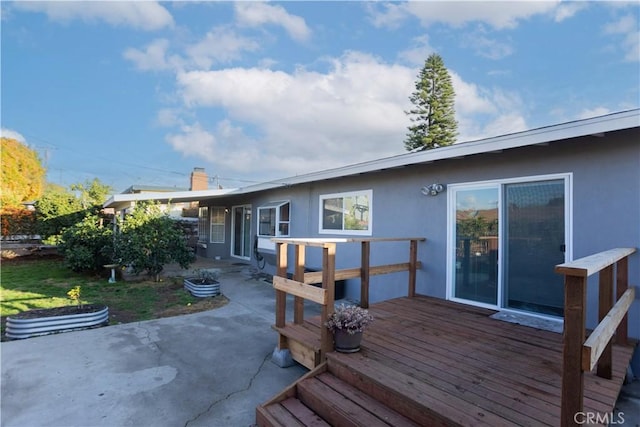 back of house featuring a patio and a wooden deck