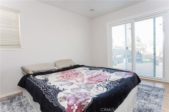 bedroom featuring access to outside and hardwood / wood-style floors