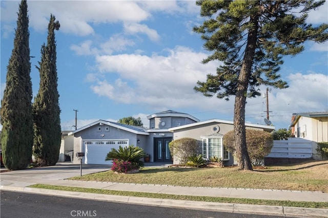 view of front of house with a garage and a front yard