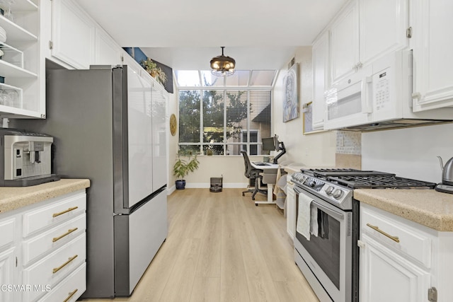 kitchen with white cabinetry, stainless steel appliances, and light hardwood / wood-style floors