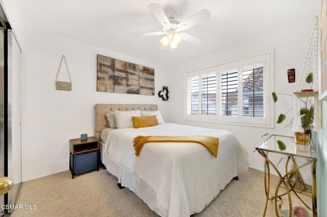 carpeted bedroom with a closet and ceiling fan