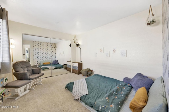 bedroom featuring carpet and a closet