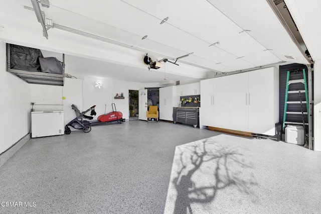 garage with a garage door opener and fridge