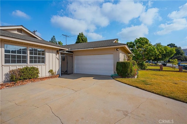 ranch-style house with a garage and a front yard