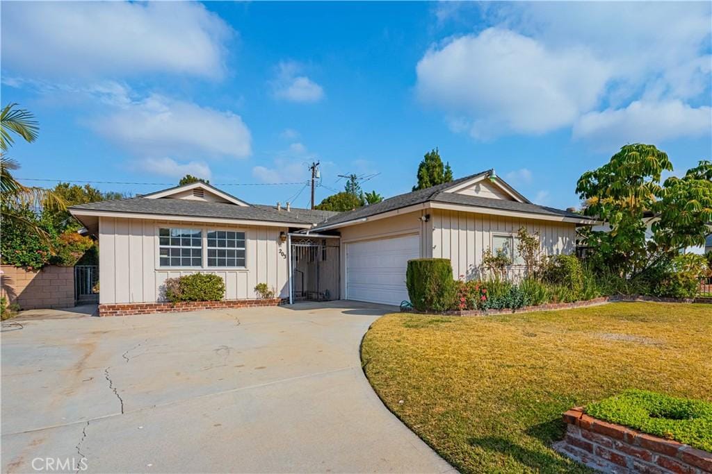 single story home with a garage and a front yard