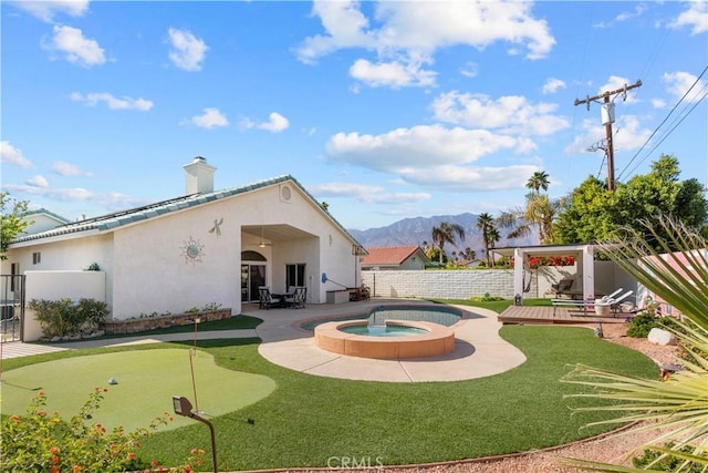 view of pool with a mountain view, a fenced backyard, a patio, and an in ground hot tub