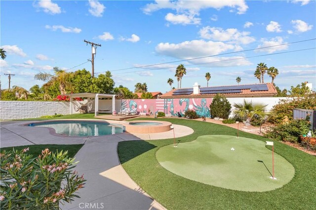 view of pool featuring a patio area, a fenced backyard, and a pool with connected hot tub