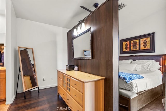 bedroom with dark hardwood / wood-style flooring and ceiling fan