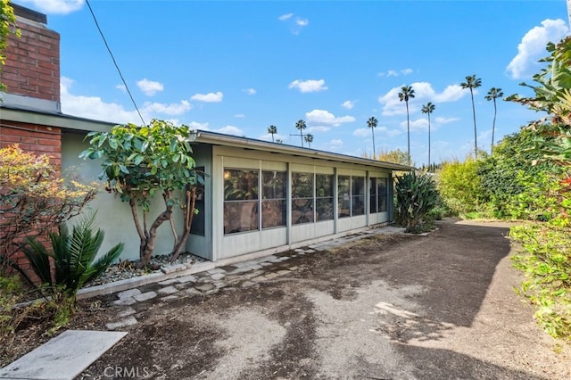 back of house featuring a sunroom