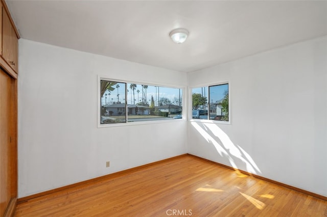 spare room with light hardwood / wood-style flooring